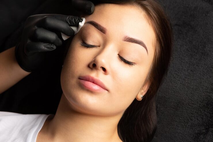 tattoo master finishing permanent tattoo work cleaning brows